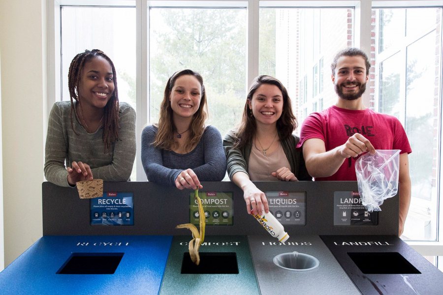 Four Bates EcoReps -- Isa Moise '19 of Mount Vernon, N.Y., Beanie O'Shea '18 of Somers, Conn., Hannah Slattery '18 of Gilford, N.H., and George Fiske '19 of West Hartford, Conn. -- show off one of the college's new waste-sorting stations, in Pettengill Hall. (Josh Kuckens/Bates College)
