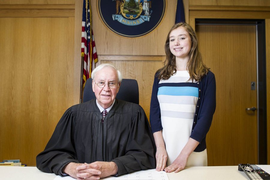 In August 2015, Claire Brown '17 poses with Judge John Beliveau at the Maine District Court in Lewiston. Her judicial internship, which inspired her honors thesis research on adult drug court effectiveness, was funded in 2015 and 2014 by the college’s Harward Center for Community Partnerships. (Josh Kuckens/Bates College) 