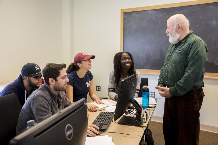 Economics professor Michael Murray works with students in his econometrics course on April 3 during the final week of classes. (Phyllis Graber Jensen/Bates College) 