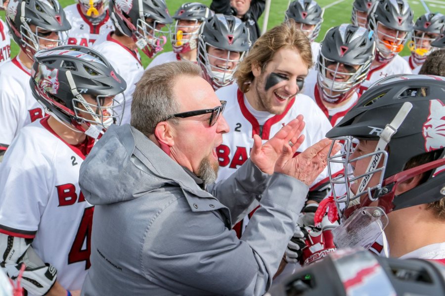 Head coach Peter Lasagna and the men’s lacrosse team celebrate after defeating Middlebury at Garcelon Field. The win put Bates at 10-0. (Brewster Burns for Bates College)