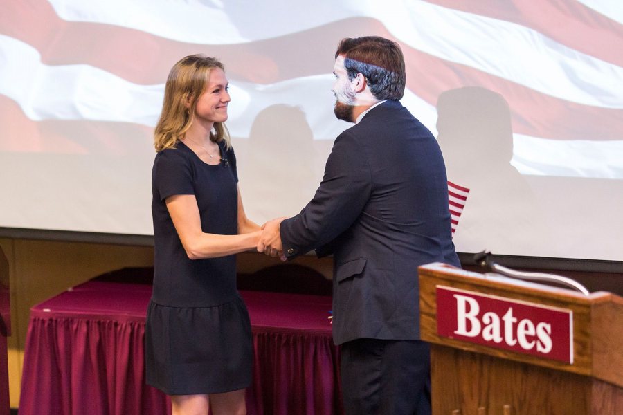 Molly Chisholm '17, playing a fictional Republican governor of Massachusetts, shakes hands with her mock-election opponent Gabriel Nott '17 during a debate held as part of the 2017 "Presidential Campaign Rhetoric." (Josh Kuckens/Bates College)