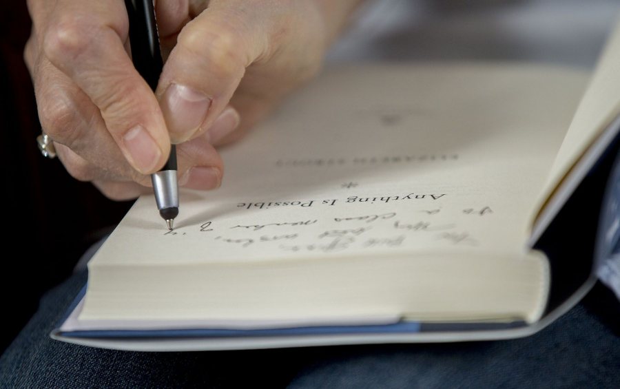 Elizabeth Strout '77 signs a copy of Anything Is Possible for a Reunion-goer. (Phyllis Graber Jensen/Bates College)