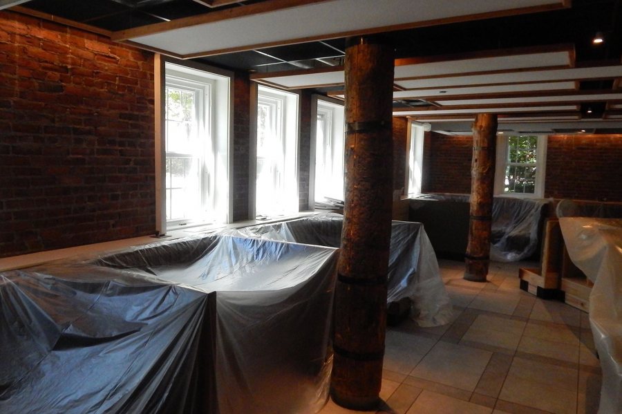 It's a wrap: Booths in the Den are protected with plastic sheeting as new heating and air conditioning equipment is installed. (Doug Hubley/Bates College)