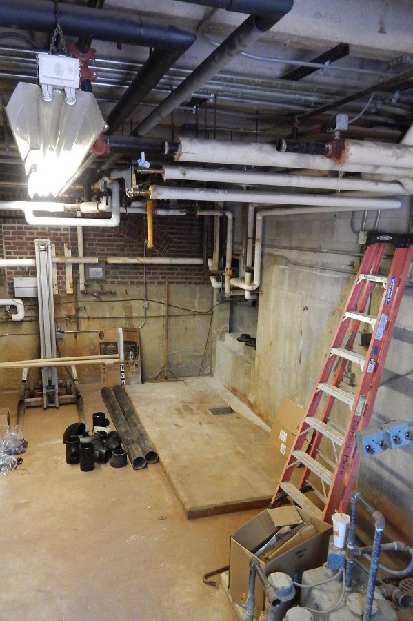 Shown on June 14, 2017, the Chase Hall mechanical room awaits a major installation of steam heat-exchange and hydronic equipment. (Doug Hubley/Bates College) 