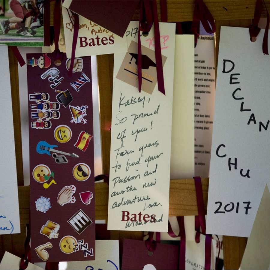 The seniors process and recess through an arch adorned with prayers, poems, and blessings offered by family members. (Phyllis Graber Jensen/Bates College)