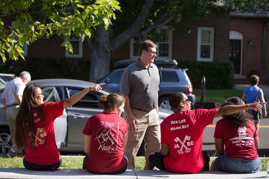 Pointing new students and families toward their destinations is job No. 1 on Opening Day. In this image from 2016, members of Residence Life, AESOP trip leaders, and Orientation Week Leaders steer a dad toward Kalperis Hall. (Phyllis Graber Jensen/Bates College)