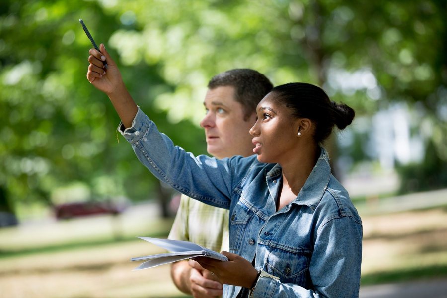 First-Year Seminars begin during Orientation. In this image from 2016, Assistant Professor of Biology Brett Huggett teaches basic techniques to observe and document natural life to Paige Rabb '20 of Stamford, Conn., a student in the First Year Seminar "The Natural History of Maine's Neighborhoods and Woods. (Phyllis Graber Jensen/Bates College)