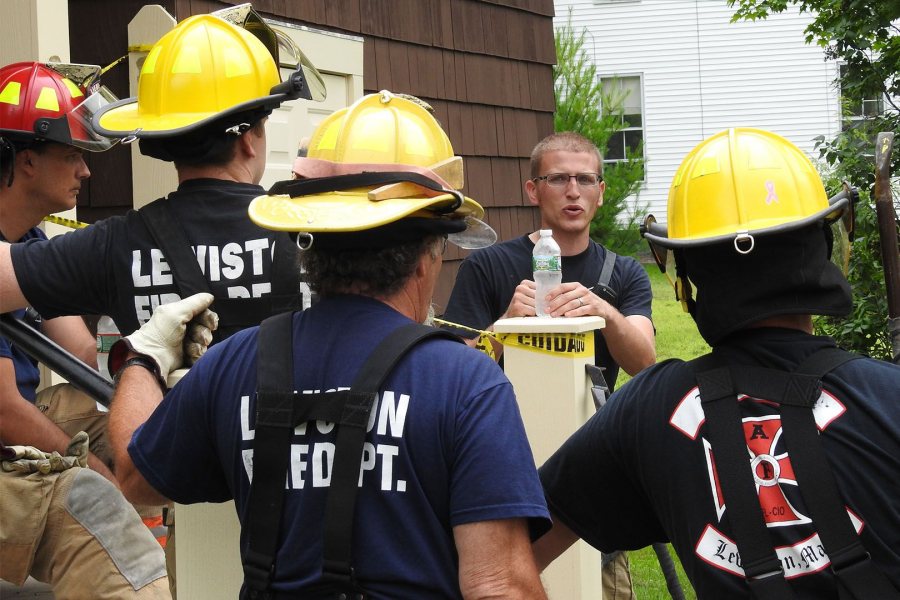 Lewiston firefighter Eric Watson, the training leader, talks to his firefighters on July 18, the first of three days of training at Holmes House. (Jay Burns/Bates College)