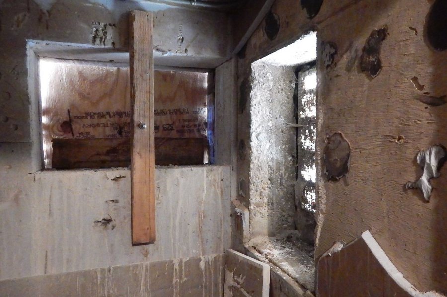 These openings supply outdoor air for the Den's air handlers. Dirt, dead leaves and other detritus tended to clog the old vent, at right, which simply introduced air into this closet space. It will be closed. The new vent will be louvered and ducted directly to the handler. (Doug Hubley/Bates College)