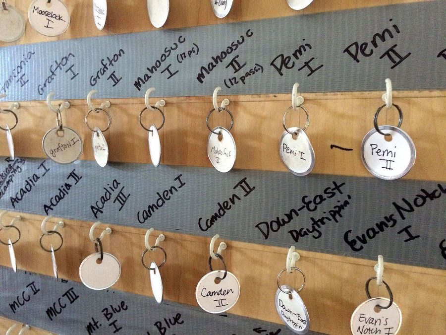 Empty keytags hang on a board in Memorial Commons below the names of various destinations for first-year AESOP trips during Orientation. The keytags will soon be filled with vehicle keys for 60 vans and trucks that will take first-years on their outdoor and service trips throughout Maine and New Hampshire. (Jay Burns/Bates College) 