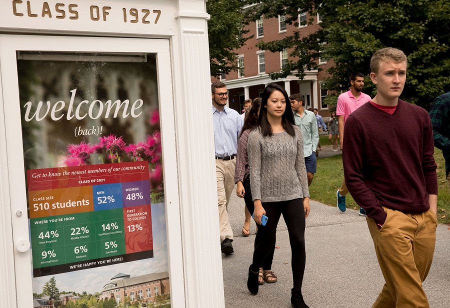 Members of the Class of 2021 process past the Class of 1927 "mouthpiece," whose message suits the occasion. (Phyllis Graber Jensen/Bates College)