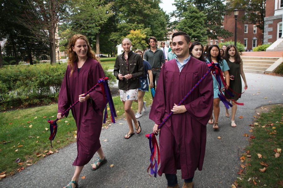 Isabella Miller ' 18 of New York, N.Y., and John Dello Russo '18 of Revere, Mass., senior marshals, reacts while leading their classmates at the start the Processional during the Opening Convocation on Tuesday. (Theophil Syslo/Bates College)