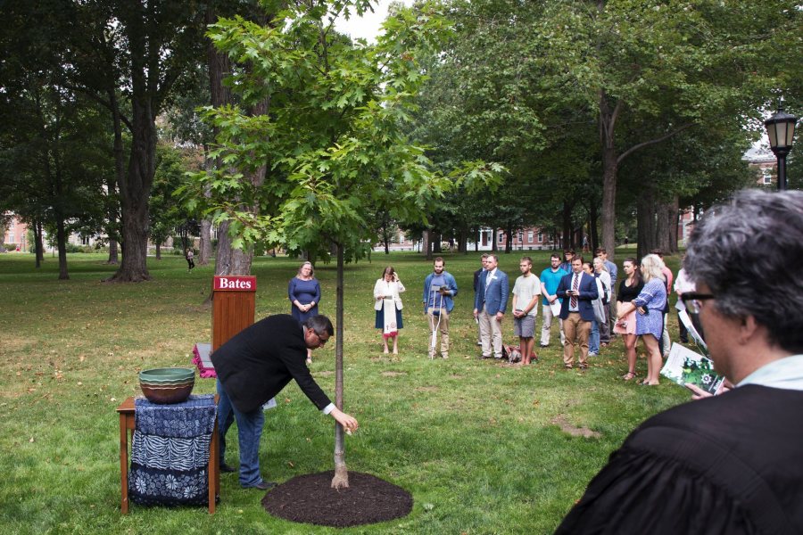 Members of the Bates community participate in a Memorial Tree Planting on the Quad across from Lindholm House immediately following the Convocation on Tuesday. A tree was planted in memory of all those in the Bates community who died during the past year.