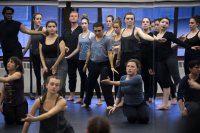 A moment for reflection: The dance repertory performance class appears in a mirrored wall in the Plavin studio. (Theophil Syslo/Bates College)