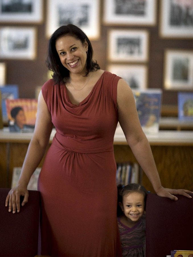 Krista Aronson poses in Ladd Library with her daughter Hope, age 2.