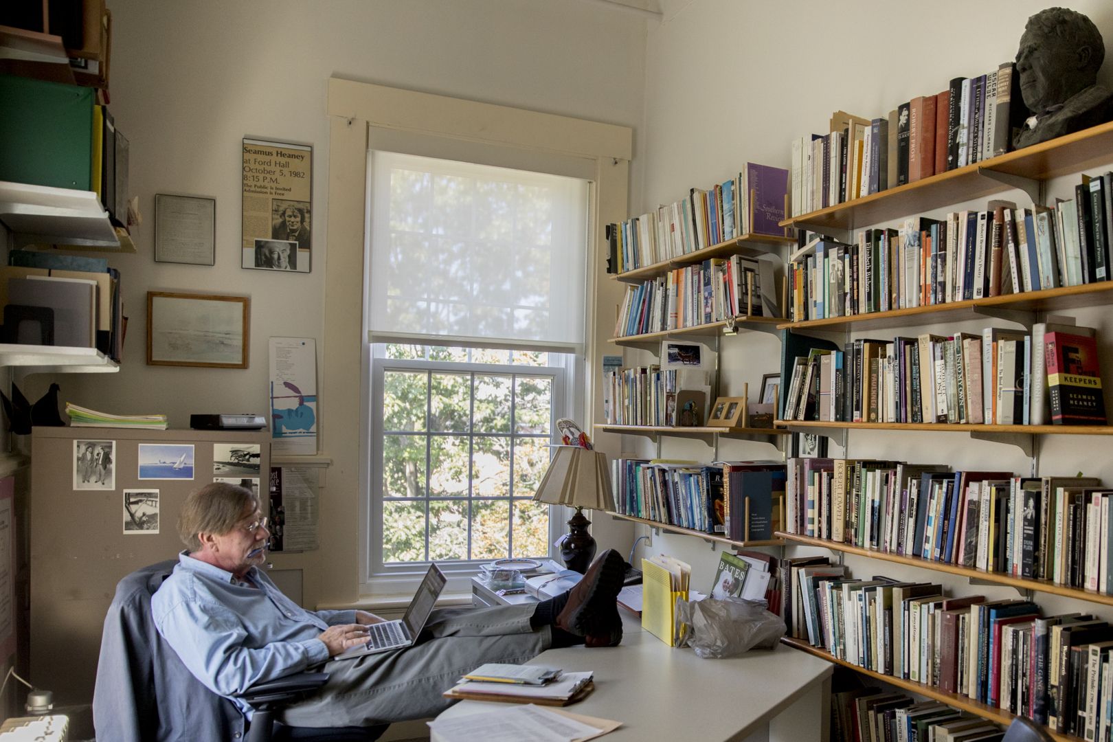 His Hathorn Hall office gives Rob Farnsworth, poet and senior lecturer in English, a great view. But the poet too is being viewed — by a bust of Robert Frost, “presiding over everything that gets said in here,” says Farnsworth. “He’s a sobering presence.” (Phyllis Graber Jensen/Bates College)
