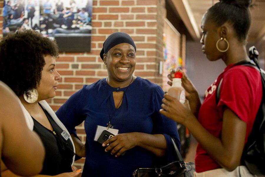 Bobcat First! students and family members of listen to a presentation during a B1st reception at the Office of Intercultural Education during Back to Bates Weekend. (Phyllis Graber Jensen/Bates College)