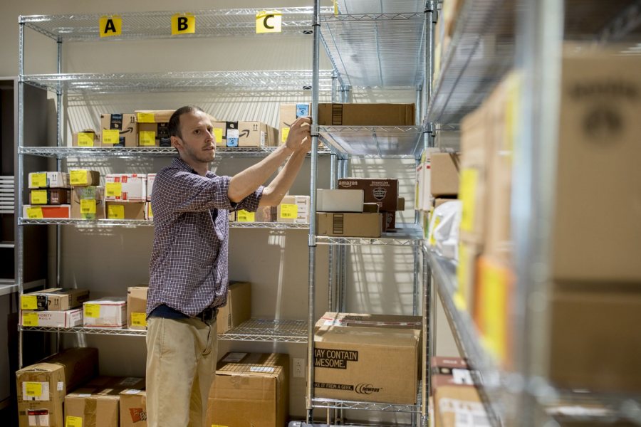 Bobby Bosse, supervisor of mail and package services at Post & Print, sorts package deliveries on Oct. 10. Post & Print will receive upwards of 70,000 by the end of 2017. (Phyllis Graber Jensen/Bates College)