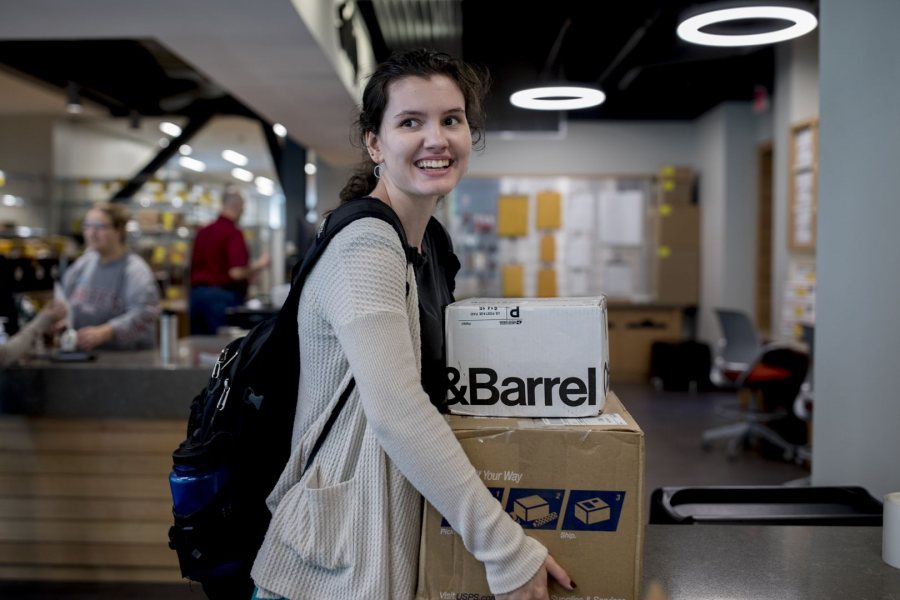 Katie Stone '19 of Riverwood, R.I. carries away birthday gifts sent by friends and relatives on Oct. 10. (Phyllis Graber Jensen/Bates College). 