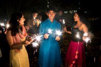 In the Muskie Garden, Jhansi Kolli ’21, Armaan Mecca ’21, and Prarthana Mocherla ’21 light sparklers to celebrate Diwali, the Hindu celebration of light. (Theophil Syslo/Bates College)