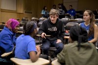 In the Filene Room, Tonelli talks with Lewiston High School track athletes following a screening of the documentary Freedom Runners, about an Israeli teacher who creates a running team for his students, young African refugees and asylum seekers. The screening was a collaboration between the Maine Jewish Film Festival and the Harward Center for Community Partnerships. (Phyllis Graber Jensen/Bates College)