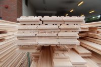 Stacked on pallets, tongue-and-groove flooring sits near the Commons truck bay as workers for New England Sports Floors start loading it into Alumni Gym on May 3. (Doug Hubley/Bates College)                            