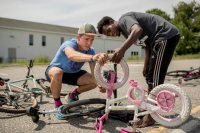 Eliot Chalfin-Smith '21 of Gainesville, Fla., has a summer 2018 Harward Center Community Partnership fellowship with the Maine Cycling Club at Tree Street Youth, 144 Knox St., Lewiston.

He is shown with Tree Street Youth working in the lot behind Tree Street's facility on the side that faces the Lewiston Colisee. They are maintaining bikes and racing through a course during the second-to-last session of the summer program.

Eliot works with Adolphe, 12, wearing a green and yellow striped shirt.