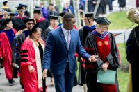 Speakers at Convocation 2018 lead the Sept. 4 processional: from left, Multifaith Chaplain Brittany Longsdorf (red gown), Bates Student Government President Walter Washington '19, historian and Convocation keynote speaker Joseph Hall, and Bates President Clayton Spencer. (Phyllis Graber Jensen/Bates College)