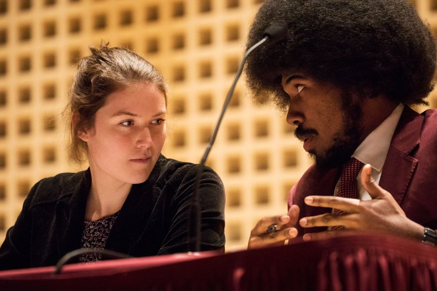 Abby Westberry '19 (left) and Morehouse College senior William Coggins, teammates for the annual Benjamin Elijah Mays Debate on Martin Luther King Jr. Day in 2018, confer prior to the debate's start. (Theophil Syslo/Bates College)