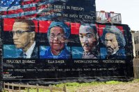 Mural on the wall of row houses in Philadelphia. The artist is Parris Stancell, sponsored by the Freedom School Mural Arts Program.Left to right; Malcolm Shabazz (Malcolm X), Ella Baker, Martin Luther King, Frederick Douglass.The quote above the pictures,"We Who Believe in Freedom Cannot Rest", is from Ella Baker, a founder of SNCC (Student Non-Violent Coordinating Committee), a civil rights group. which amongst other contributions, helped to coordinate "Freedom Rides"in the early 1960's.Tony Fischer [CC BY 2.0 (https://creativecommons.org/licenses/by/2.0)], via Wikimedia Commons