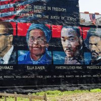 Mural on the wall of row houses in Philadelphia. The artist is Parris Stancell, sponsored by the Freedom School Mural Arts Program.Left to right; Malcolm Shabazz (Malcolm X), Ella Baker, Martin Luther King, Frederick Douglass.The quote above the pictures,"We Who Believe in Freedom Cannot Rest", is from Ella Baker, a founder of SNCC (Student Non-Violent Coordinating Committee), a civil rights group. which amongst other contributions, helped to coordinate "Freedom Rides"in the early 1960's.Tony Fischer [CC BY 2.0 (https://creativecommons.org/licenses/by/2.0)], via Wikimedia Commons