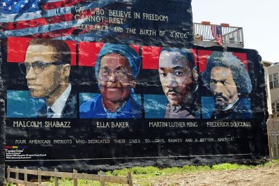 Mural on the wall of row houses in Philadelphia. The artist is Parris Stancell, sponsored by the Freedom School Mural Arts Program.Left to right; Malcolm Shabazz (Malcolm X), Ella Baker, Martin Luther King, Frederick Douglass.The quote above the pictures,"We Who Believe in Freedom Cannot Rest", is from Ella Baker, a founder of SNCC (Student Non-Violent Coordinating Committee), a civil rights group. which amongst other contributions, helped to coordinate "Freedom Rides"in the early 1960's.Tony Fischer [CC BY 2.0 (https://creativecommons.org/licenses/by/2.0)], via Wikimedia Commons