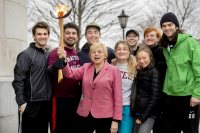 After lighting the ceremonial Winter Carnival torch at the State House in Augusta this morning, Maine Gov. Janet Mills poses with, from left, Nathan Delmar '21 of Manchester, Maine; Gordon Platt '19 of Groton, Mass.; Eliot Chalfin-Smith '21 of Gainesville, Fla.; Abigail Kany '21 of Phoenix; Brianna Karboski '21 of Williamstown, N.Y.; Anna Mangum '21 of Atlanta; Ronan Goulden '22 of Lagunitas, Calif.; and Alex Platt '22 of Groton, Mass. (Phyllis Graber Jensen/Bates College)