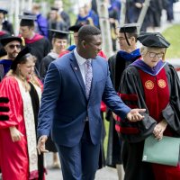 Convocation, held at 11 a.m. today on the Historic Quad, “provided Bates with an opportunity to welcome the Class of 2022, to celebrate the opening of the college, and to consider, as a community, our shared goals and hopes for the academic year,” said President Clayton Spencer..Led by the College Mace Bearer Michael Murray, Phillips Processor of Economics, the Convocation procession included President Spencer, Student Body President Walter Washington '19 of Fleetwood, N.Y., and Associate Professor of History Joe Hall..According to Spencer, “the College has resuscitated what was once a Convocation tradition at Bates: asking the outgoing senior class to select a faculty speaker for the incoming freshman class.” In this case, the Class of 2018 chose Hall to address the Class of 2022 -- and the entire Bates community. His talk was titled, “Questions for Bates.”.Immediately following Convocation, members of the Bates community attended a brief tree-planting ceremony, on the Quad behind Carnegie Science, held in memory of those in the Bates community who died during the past year. The ceremony was followed by a lunch will be served on the Library Quad for the college community.