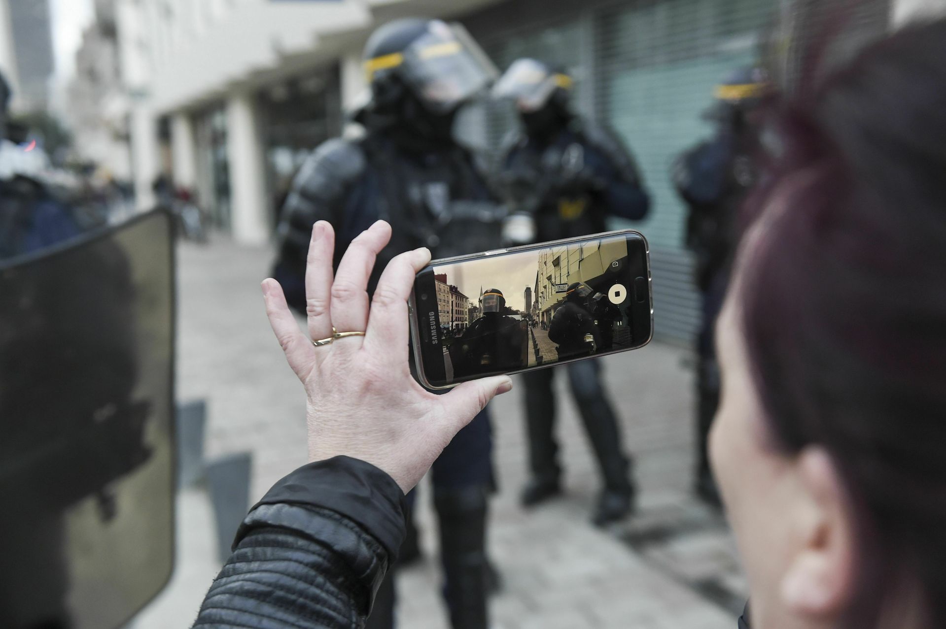 A protestor recording with her smartphone during an anti-government demonstration called by the Yellow Vests "Gilets Jaunes" movement in Nantes, western France, on March 02, 2019. 'Yellow vest' anti-government protesters have taken to the streets in France for the 16th consecutive Saturday on February 02 2019. (Sipa via AP Images)