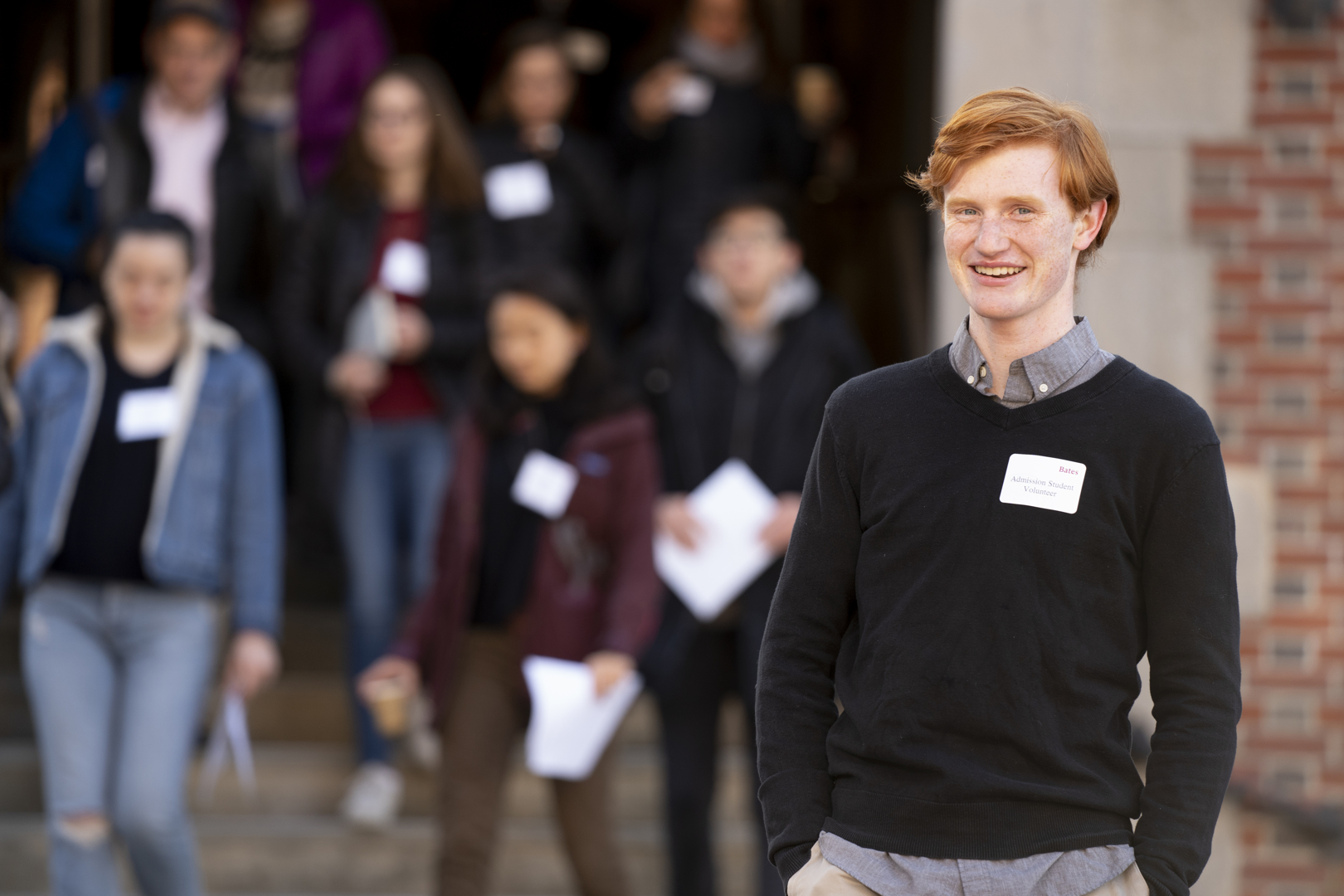 “It’s super exciting to have new Bobcats on campus. I’m kind of the first person in the line of everybody who’s welcoming them today.”.— Admission tour guide Ronan Goulden ’22, an environmental studies major from Lagunitas, Calif., standing outside of Chase Hall, where newly admitted members of the Class of 2023 arrived and departed for a series of events, including an official welcome from President Clayton Spencer.Emily Bowen, other tour guide in headband;Abby Graumann ‘22, holds master class won.