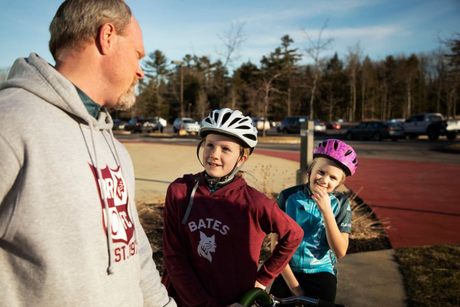 Chip Noble 97 of Yarmouth, and daughter's Abby, 10 and Emma, 7, pose for a portrait outside of Garmin's headquarters in Yarmouth on April 11, 2019.