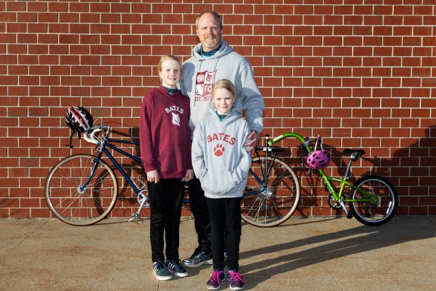 Chip Noble 97 of Yarmouth, and daughter's Abby, 10 and Emma, 7, pose for a portrait outside of Garmin's headquarters in Yarmouth on April 11, 2019.