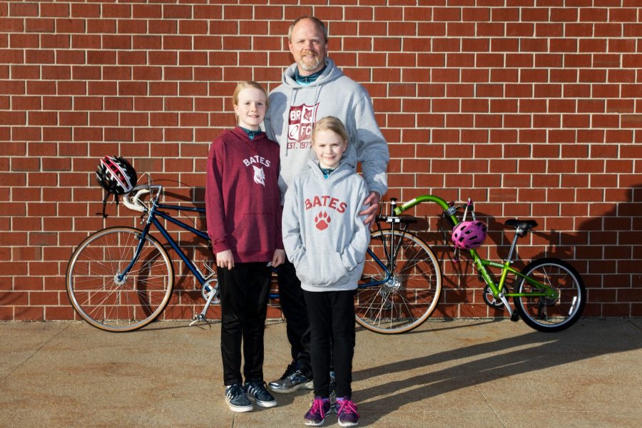 Chip Noble 97 of Yarmouth, and daughter's Abby, 10 and Emma, 7, pose for a portrait outside of Garmin's headquarters in Yarmouth on April 11, 2019.