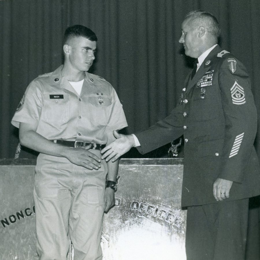 In May 1969, David Nash '68 is congratulated by First Sgt. Raymond Jenkins as a Distinguished Graduate of his noncommissioned officer training program at Fort Benning, Ga. (Photograph by Sgt. L. Herrmann)