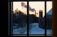 A day in the life of Pettengill Hall, featuring staff, faculty and students engaged in learning, studying, and working, with both internal and external images.Looking through the windows of the second floor AAACS lounge toward the Cutten smokestack.