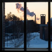 A day in the life of Pettengill Hall, featuring staff, faculty and students engaged in learning, studying, and working, with both internal and external images.Looking through the windows of the second floor AAACS lounge toward the Cutten smokestack.