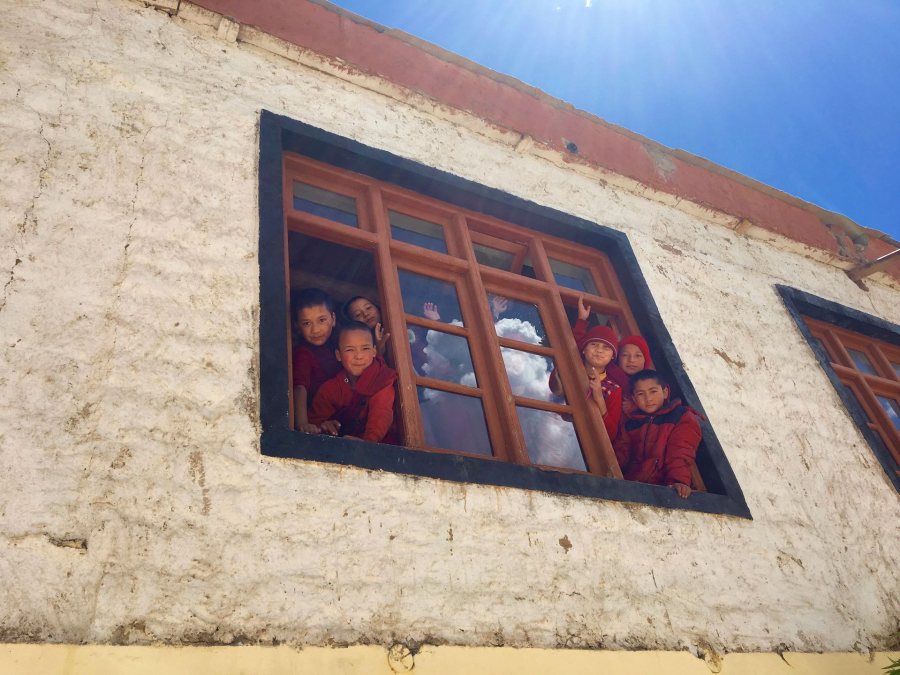 Sullivan, Lydia India ST 2018 Novice monks peering their heads out of the window of their classroom at the Skurbuchan Monastery in Ladakh, India. They waved goodbye as we left the monastery to hike down to our campsite in the village.This photo was selected for the 2019 Barlow Off-Campus Photography Exhibition and shown at the 2019 Mount David Summit on March 29, 2019.