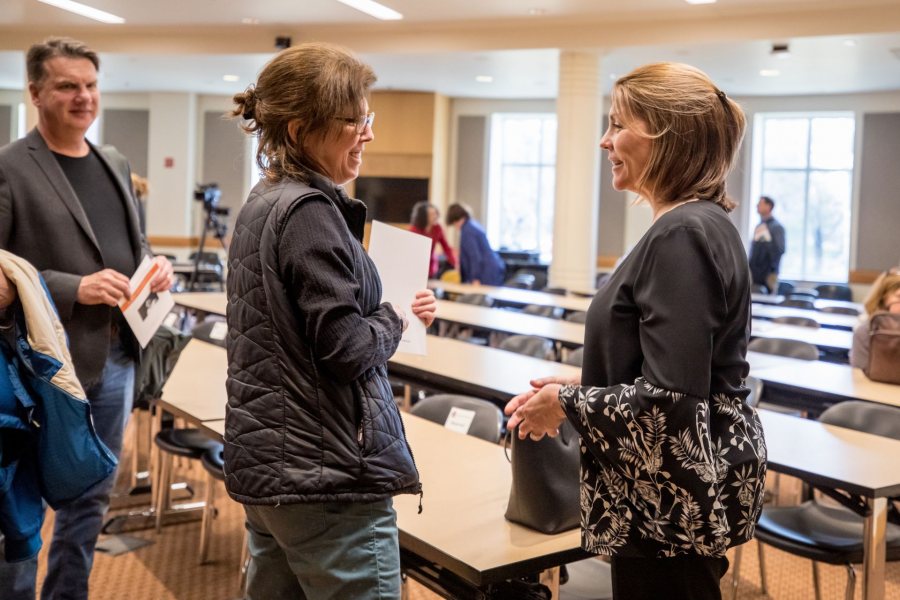 April Hill (right) talks with Elmer W. Campbell Professor of Economics Lynne Lewis following her inaugural lecture as the Wagener Family Professorship of Equity and Inclusion in STEM. (Rene Roy for Bates College)