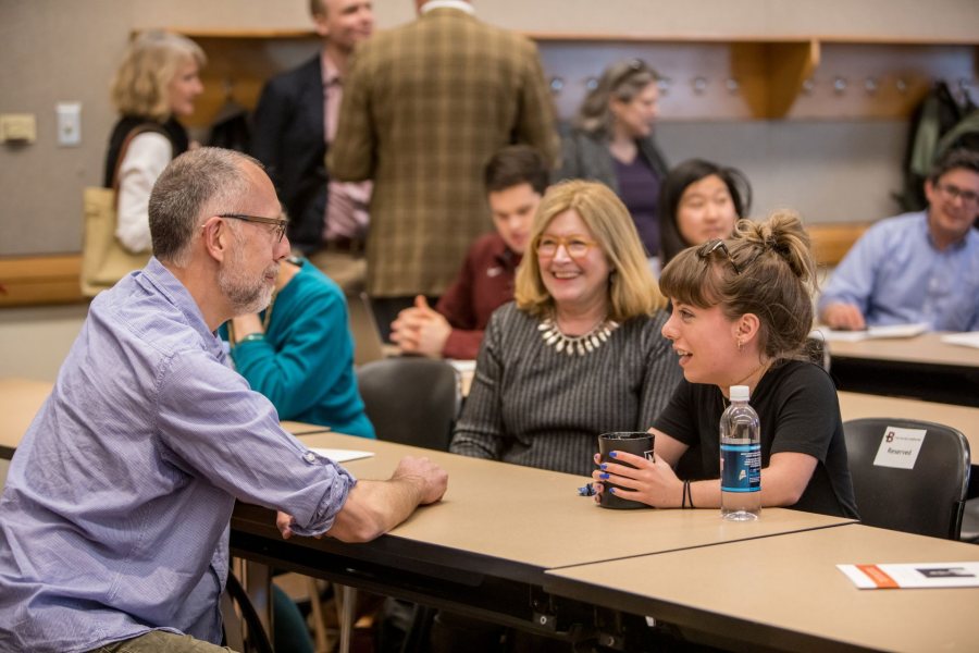 Prior to April Hill's talk, Sophie Wagener '17 (right) talks with Professor of Biology Donald Dearborn (left) as Vice President of College Advancement Sarah Pearson '75 looks on. (Rene Roy for Bates College)