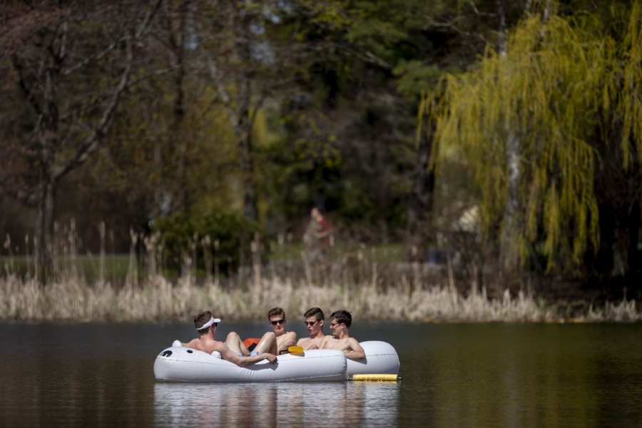 After a week of rain, a warm and sunny day filled with the sights and sounds of spring. "I feel really bad because a polar bear doesn't belong on the Bates Puddle." -- Matt Clayton of Wayland, Mass., who with his friends bought the blowup boat online in November. They plan to be out on the Puddle, where thy have installed an orange buoy to anchor the craft, every nice day they get. They rationalize that by floating around on a Bowdoin mascot, they are "sitting on top of Bowdoin." Sitting alone without oars and white hat: Jackson Elkins '22 of Deerfield, Mass., Nic Stathos '22 of Wellesley Hills, Mass., and Matt Clayton '22 of Wayland, Mass. Fourth to join the boat: Max Bartley '22 of Presque Isle, Maine, sits on far right.