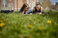 A beautiful spring day in May on Alumni walk where from left, Charlotte Collins '22 and Cathering Butler '22 enjoy "he perfect opportunity to read books for pleasure," says Butler.