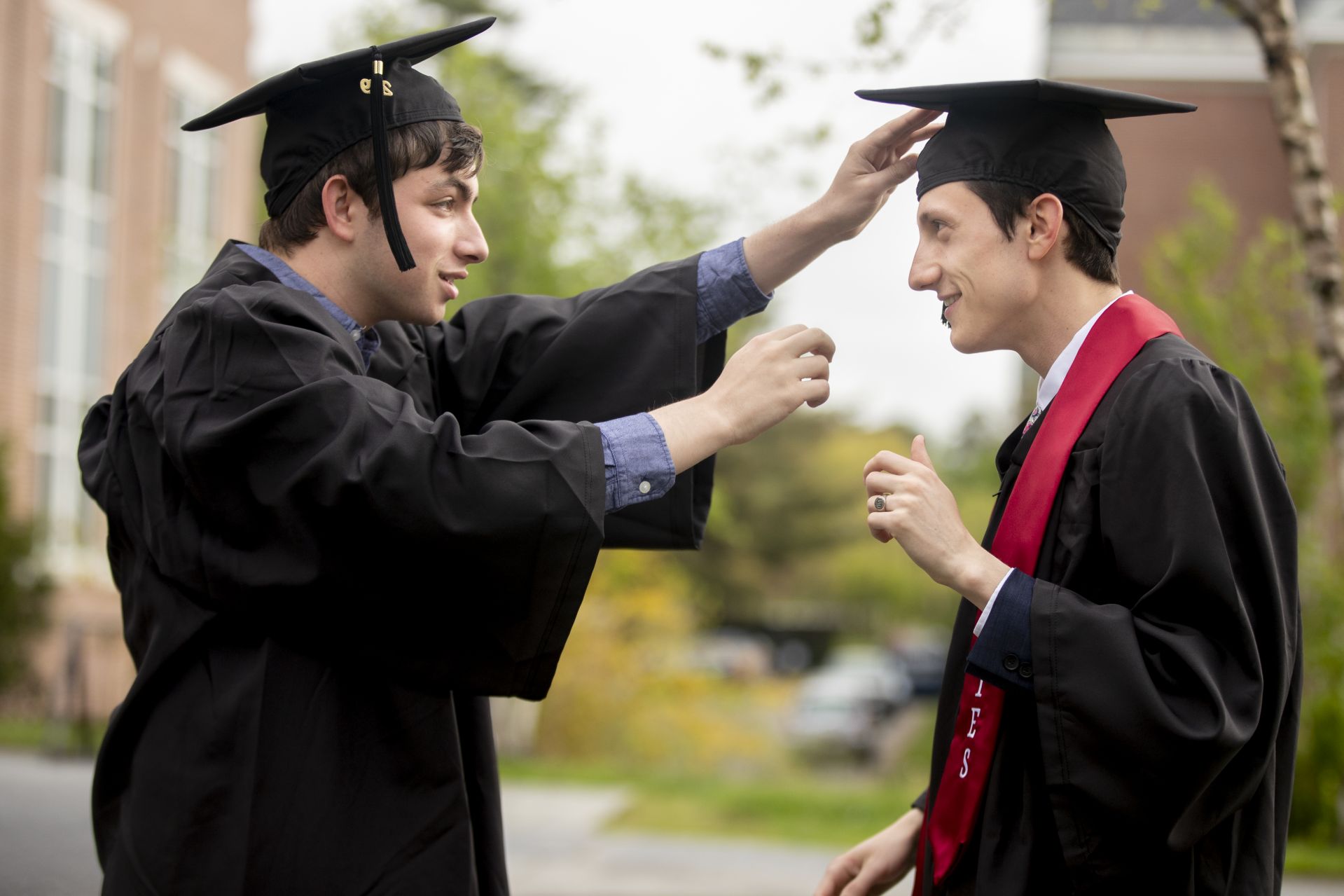 The first seniors on Alumni Walk on Commencement Day, David Unterberger (left) and Nicholas Damianos check each other's cap alignment. (Phyllis Graber Jensen/Bates College)