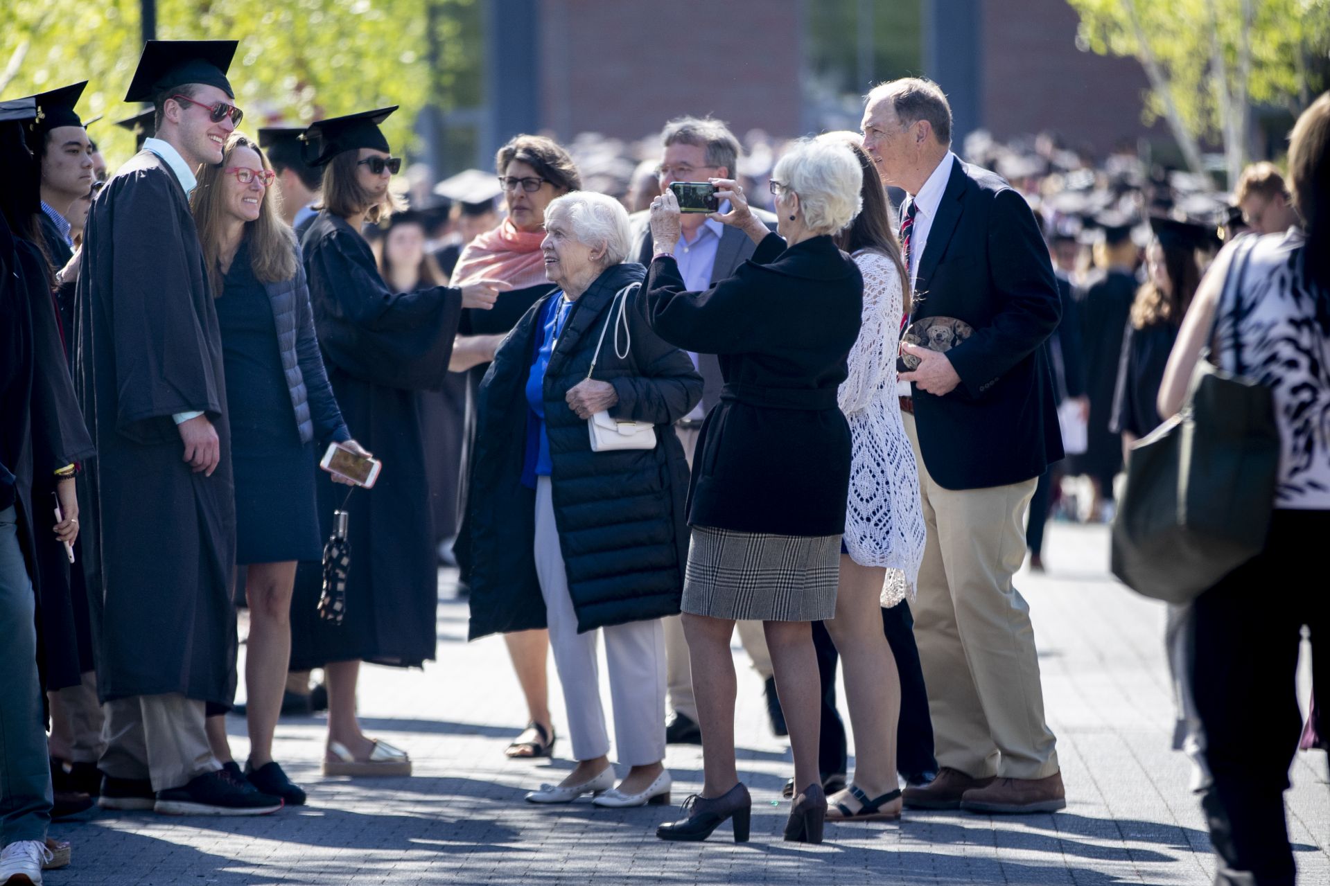 Bates College 2019 Commencement (the one hundred and fifty-third) on the Historic Quad, at which Travis Mills receives an Doctor of Humane Letter. Placing the collar on Mills is the college's mace bearer, Charles Franklin Phillips Professor of EconomicsMichael Murray.