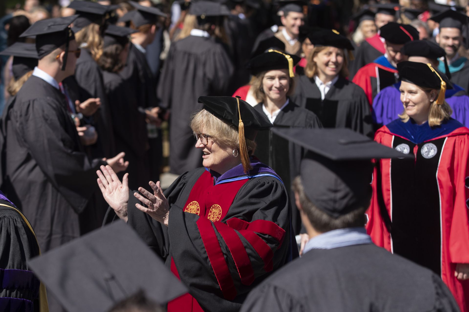 Bates College 2019 Commencement (the one hundred and fifty-third) on the Historic Quad, at which Travis Mills receives an Doctor of Humane Letter. Placing the collar on Mills is the college's mace bearer, Charles Franklin Phillips Professor of EconomicsMichael Murray.